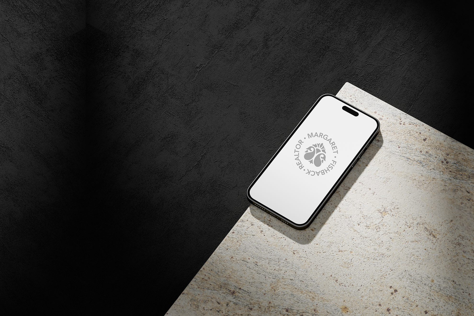 A black and white image of a cell phone that has the elegant Margaret Fishback Realtor logo on the screen.